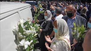 A woman searches for her relative's name on the coffins of newly identified victims of the 1995 srebrenica massacre, at the memorial center in potocari near srebrenica, bosnia and herzegovina. Families Recall Last Moments With Srebrenica Victims