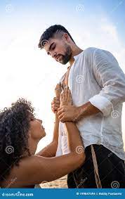 Kneeling Submissive Woman Begs Her Man by Holding His Hands on His Massive  Chest, but he Squeezes Her Wrists As a Sign of Stock Photo - Image of  family, jealousy: 199847594