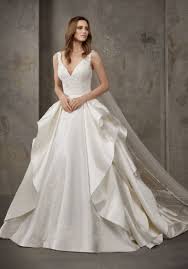 For brides choosing a wedding dress, they want something unique and different. Pronovias Privee Niala Embroidered Satin Ball Gown With Ruffles Designer Bridal Room