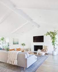 The living room is done in white and neutrals and bold red curtains and a black couch stand out a lot here. Minimal Mid Century Modern Get The Look With The Konmari Method Home