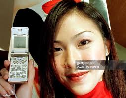 A model holds up the world's smallest hand phone called the "Sewon... News  Photo