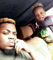 The rapper was pictured having fun with his son inside his car. Olamide His Son Biatifeori Are Twinning In New Photo Celebrities Nigeria