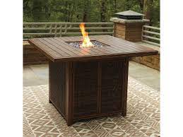 This table is highly durable and the uses for it are flexible, giving you plenty of options on warm nights. Signature Design By Ashley Paradise Trail Square Bar Table With Fire Pit Royal Furniture Outdoor Fire Pits