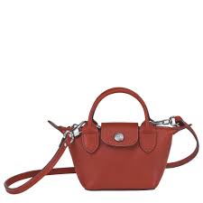 Inspired by origami, longchamp created le pliage, a lightweight foldable bag that is now a classic all over the world. Umhangetasche Xs Le Pliage Cuir Ockerbraun 10099757003 Longchamp At