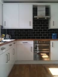 The crisp, clean shaker cabinets are both classic and modern. Not Sure I Like Black Tiles Kitchen Cabinet Design Kitchen Flooring Black Kitchen Cabinets