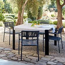 The alluring outdoor dining set offers chairs made of pvc and polyester, and an umbrella made of olefin. Outdoor Dining Tables Metal Glass More Crate And Barrel