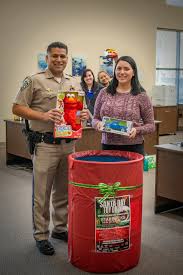 OUR SANTA DAY TOY DRIVE HAS BEGUN Officer Alvarez and members from our  clerical staff have made the first official toy drop. You can join in the  fun and help us make