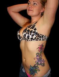 Perhaps you are thinking that it is a good tattoo to show off your religious beliefs. Amazing Colorful Flowers Tattoo On Girl Left Side Rib