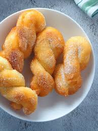 Bicho Bicho Made Of Yeast Dough Shaped Into Twisted Ropes And Deep Fried To Golden Perfection Soft Fluffy And Coated In Suga Twist Donut Recipe Food Recipes