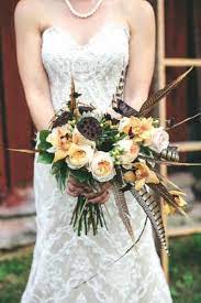 Bride with a white bouquet with feathers and crystals. Pin On Wedding Bouquets