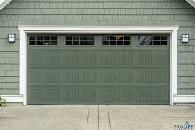 Beautiful New Garage Door In A Soft Green Tone With Decorative Panels Windows White Trim And Lights Garage Door Styles Garage Door Types Garage Door Design