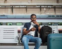 Image of solo traveler on a train