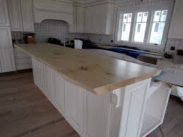 Custom teak raised kitchen bar top with durata® waterproof wood countertop finish, used for a kitchen with white cabinets in. Live Edge Wood Countertops Gallery