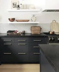 Dark gray can be a bold choice in smaller spaces, like this modern new york apartment, where glossy gray cabinets and stainless steel appliances complement a black granite countertop. Inspiration For Willow House Main House Kitchen Matte Black Cabinets With Matte Black Grani Black Kitchen Countertops Rustic Kitchen Countertops Home Kitchens