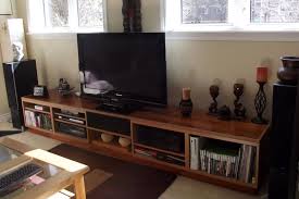 The cabinet has 4 compartments with sliding doors (with small black knobs) and thin round legs. Ultimate Entertainment Unit Ikea Hackers