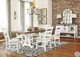 For a sleek, modern appearance, try a glass top dining room set with a clear pane resting on a metal base. Valebeck White And Brown Rectangular Dining Room Set From Ashley Coleman Furniture