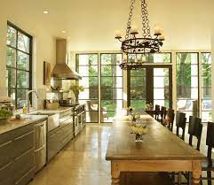 Design a kitchen island with seating that invites family members and guests to pull up a chair or stool and share conversation while you're cooking. Farmhouse Table Kitchen Island Eclectic Kitchen The Iron Gate