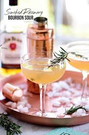 This white christmas bourbon smash cocktail recipe is the perfect holiday drink! Smoked Rosemary Bourbon Sour Cocktail Tidymom