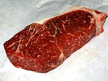 Shaved rib eye topped with melted american cheese on a crispy french roll. Strip Steak Wikipedia