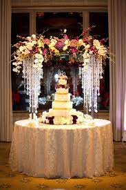 Lucite And Dripping Crystals Topped With Orchids And Hydrangea Make A Glamorous Arch Wedding Cake Display Wedding Cake Table Wedding Table Flower Centerpieces