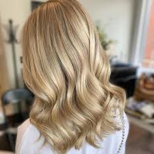 A playful half updo for layered waves. 8 Hairstyles That Make You Look Younger Wella Professionals