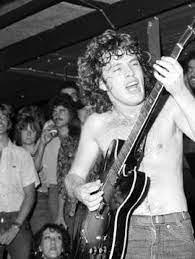 Angus In Action Pictured In The Bottom Of The Photo Is Fifa Riccobono The Godmother Of The Australian Music Industry Acdc Angus Young Acdc Angus Young