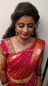 This bridal bun with a bunch of white flowers is perfect to wear with your bridal lehenga or saree on the big day. Pretty In Pink Our Bride Sowmya Looks Like A Vision For Her Reception Ceremony Hair And Indian Bridal Hairstyles Bridal Blouse Designs Indian Bride Hairstyle