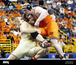 Heavyweight wrestler Steve Mocco of Oklahoma State (R) has his leg tied up  by Minnesotas Cole Konrad in the 2005 NCAA Division 1 Wrestling  Championships at the Savvis Center in St. Louis,