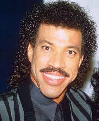 Before then, he had short hair. Farce The Music
