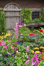 Cottage Garden The Beauty Of Messy Flowers Town Country Living Colorful Garden Cottage Garden Summer Lawn Care
