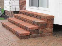 Once the patio step paver bases and capstones have set for two to four hours, inspect them and fill any visible gaps with polymeric sand to eliminate weed growth. How To Prep And Build Stair For My Paver Patio Diy Patio Stairs Brick Patios Outdoor Stairs
