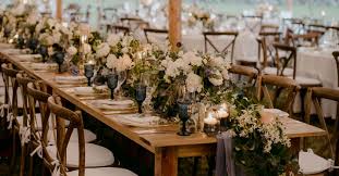 Wedding table setting with green candle and flowers. The Ultimate Guide To Wedding Reception Tables