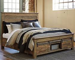 Made of replicated veneer and engineered wood, it's accented with burnished metal hardware and nailhead trim for a modern look you (or your kids) will appreciate. Trinell Queen Panel Bed Ashley Furniture Homestore