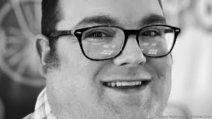 Michigan businessman Thomas Coke signs