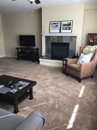 This living room features a beautiful dark wood floor, complemented by a white and gray rug in a moroccan pattern. Need Help Decorating A Living Room With Brown Carpet
