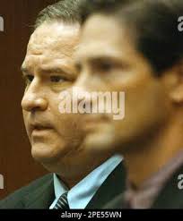 Beverly Hills real estate developer Mark Alan Abrams, 44, left, is shown  during his arriagnment in Wednesday, May 25, 2005, in Los Angeles. County  prosecutors charged Abrams Wednesday with laundering $21,000 in donations  to help finance campaigns ...