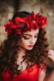 Red Sherri Hill Ballgown With Red Flower Crown On Curly Haired Brunette With Long Hair Prom Hairstyle Curly Hair Styles Red Flower Crown Flower Crown Hairstyle