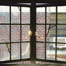 Blue slate background, feathery leaves of light brown, pink, shades of green and beige. Metal Windows In Historic Buildings Traditional Building