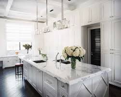 White and black kitchen cabinets already scream classic, but adding some dark wood into the picture takes it a step further. Dark Wood Floor With White Kitchen Cabinets