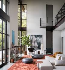 High Ceilings And Industrial Materials Are Prominent Design Elements In This New House High Ceiling Living Room Living Room Modern Interior Design