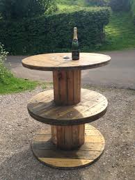 The Tables Are Made From Reconditioned Wooden Cable Drums Which Have Been Bolted Together Sanded Down And Cable Spool Cable Spool Furniture Cable Drum Table