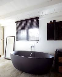 Dark Water 10 Modern Black Bathtubs Remodelista The space surrounding the freestanding tub makes the room feel more open, as does the lightweight curtain fabric, which allows maximum light to enter.
