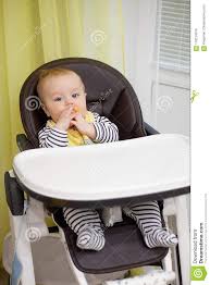 Photo About Little Baby Boy Sitting In Chair For Feeding And Eating Special Biscuit For Babies Kitchen Indoor Image O Little Babies Baby High Chair Baby Boy