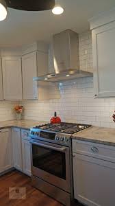 The White Koch Kitchen Cabinets Accented By A Dark Wood Finish Island And Richelieu Hardware Of Transitional Kitchen Design Kitchen Design Transitional Kitchen