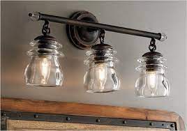 A simple bulb caged in a vintage looking frame hung on a pulley makes up for a gorgeous lighting idea that will surely compliment any setting as the light looks extremely classic and elegant. 26 Inexpensive Farmhouse Bathroom Lighting Ideas You Ll Love Homeandcraft Rustic Bathroom Lighting Farmhouse Light Fixtures Rustic Light Fixtures