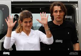 Swiss nationals Olivier David Och, right, and Daniela Widmer, left, wave to  the media after landing at Zurich airport, Saturday March 17, 2012. The  Swiss Foreign Ministry says the couple that were