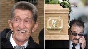 Paul carries coffin at brother Barry Chuckle's funeral