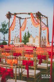 A Colorful Raw Mandap Decoration Using Minimal Amounts Of Flowers And Drapes Has Wedding Reception Decorations Rustic Mandap Design Indian Wedding Decorations
