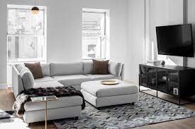 A Geometric Area Rug Incorporates The Grey Taupe And Black Color Scheme That Flows Through The Loft Grey Couch Decor Winter Living Room Gray Sofa Living