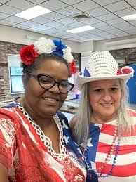 In the video is a white woman dancing a little a bit with navy blue and  black tie dye design shirt -dirty blonde hair with some grays along the  lines- white screen